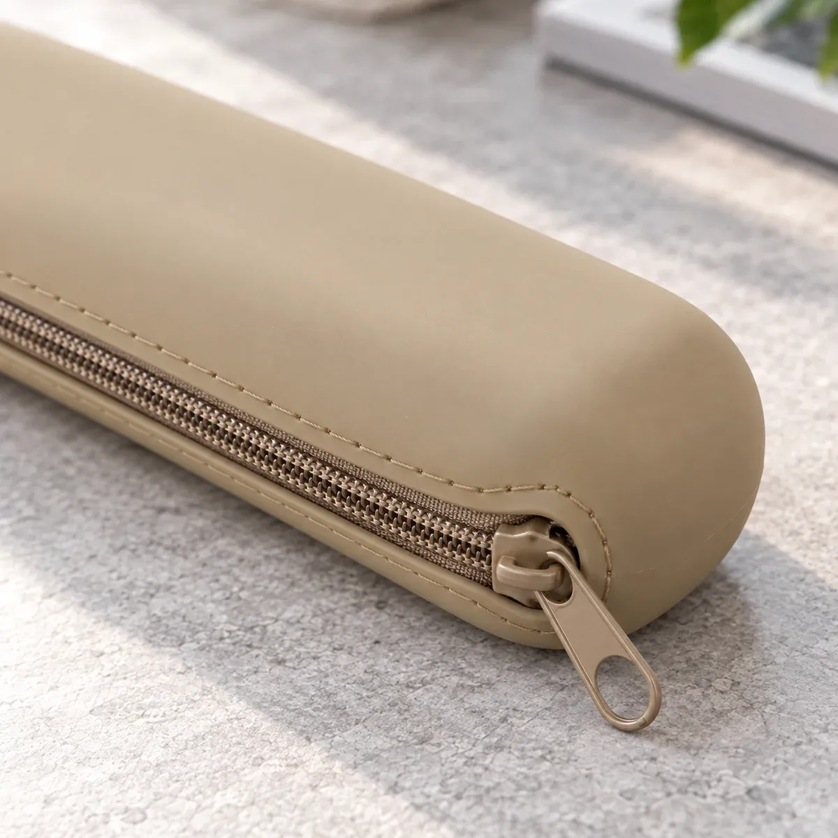 Black and khaki silicone brush cases — detail view. Makeup brushes and styling props are not included.