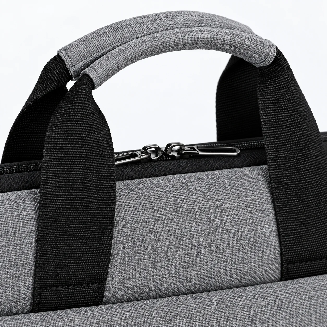 Gray tote handles and zipper in close view